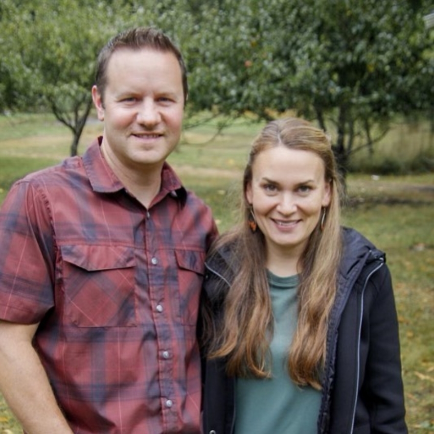 Paul and Gina smiling with trees